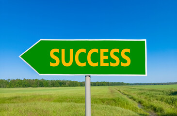 Success symbol. Concept word Success on beautiful green road sign. Beautiful blue sky green grass...