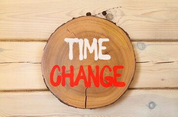 Time change symbol. Concept word Time change on beautiful wooden circle on wooden wall. Beautiful...