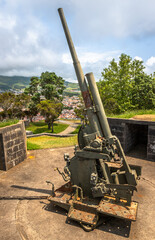 A vintage British 9.4 cm fixed anti-aircraft gun from 1940, located in a coastal fort on Terceira...