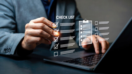 Modern business professional reviewing digital checklist on laptop for project management success