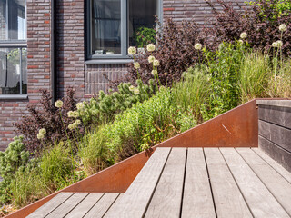 Modern Urban Garden with Wooden Deck and Metal Planter