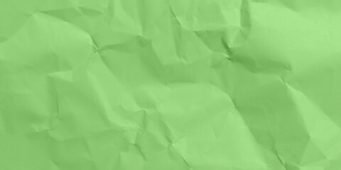 Green crumpled and creased paper poster texture background. 