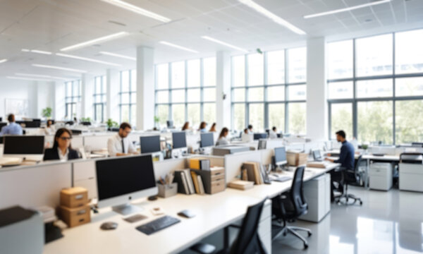 Out of focus, modern office interior with employees working on computers. Ideal for corporate, technology or business projects, conveying a tense atmosphere