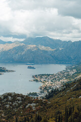 view on a lake from the mountains close to the clouds