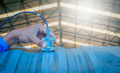 Inspector use ultrasonic testing machine for inspection defect in steel structure.