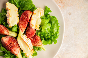 Salad figs, soft cheese, green leaf lettuce tasty snack fresh delicious gourmet food background on the table rustic food top view copy space keto and paleo diet vegetarian food