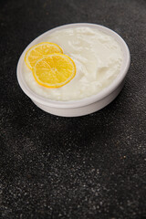 Lemon yogurt natural product skyr sour milk skir fresh delicious gourmet food background on the table rustic food top view copy space keto and paleo diet vegetarian food