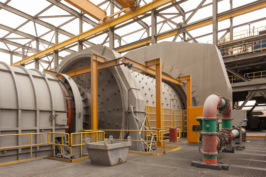 Inside a copper mining plant, the powerful machinery of a mineral mill stands ready to process raw ore from the mine.