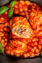 Stuffed cabbage tomato sauce with beans meat, cabbage, fresh delicious gourmet food background on the table rustic food top view copy space