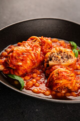 Stuffed cabbage tomato sauce with beans meat, cabbage, fresh delicious gourmet food background on the table rustic food top view copy space
