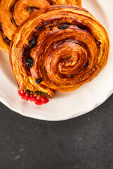 Raisin bun sweet pastry dessert puff pastry fresh delicious gourmet food background on the table rustic food top view copy space