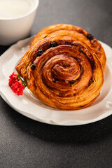 Raisin bun sweet pastry dessert puff pastry fresh delicious gourmet food background on the table rustic food top view copy space