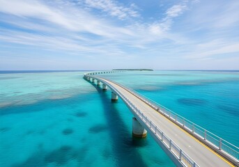 Obraz premium Long bridge over turquoise coral reef waters leading to distant island under blue sky, tropical travel and transportation concept