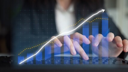 A businesswoman engaging in data analysis, typing on a laptop with an engaging graph overlay,...