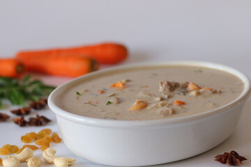 Kerala style mutton stew in a white bowl, made with tender mutton, carrots, coconut milk, curry...