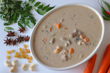 Kerala style mutton stew in a white bowl, made with tender mutton, carrots, coconut milk, curry...