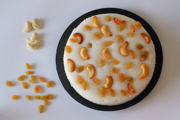Vattayappam, a steamed rice cake from Kerala, topped with golden raisins and roasted cashews
