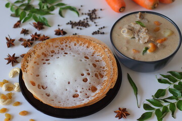 Kerala style appam with mutton stew in coconut milk gravy, styled with curry leaves, spices, and...