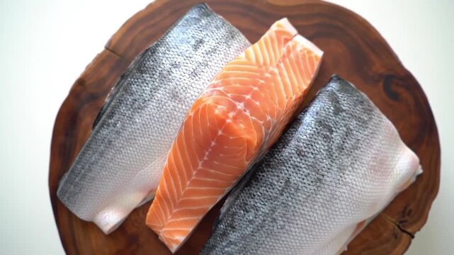 Top-down shot of Alaskan salmon on wooden board, crisp focus, pure white background