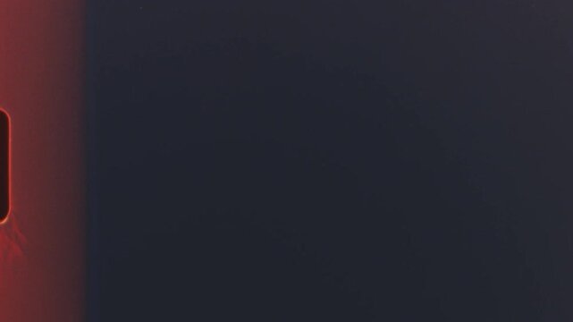 Abstract grainy texture from 8mm film reel with dark tones and light leaks