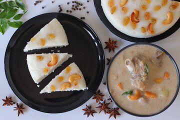 Kerala style vattayappam topped with golden raisins, sliced and served with mutton stew in coconut milk gravy