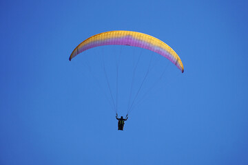 Flight bright paraglider in the blue sky parachute-wing