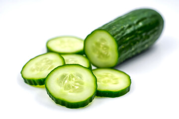 Fresh green cucumber and slices on a white background representing healthy eating and the vegetable as a snack option