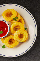 Colmar rings fried food fries fast food crispy appetizer fresh delicious gourmet food background on the table rustic food top view copy space