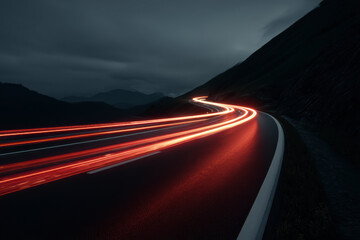Road curves with light trails at night, motion and speed captured on mountain asphalt.