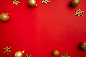 Christmas and Happy New year background with gold glitter decorations on red bright background. Holiday party decoration . Christmas celebration, holiday card