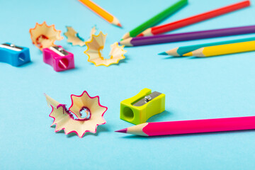 Pencil sharpener on bright colored background. Pencil and pencil shavings. Stationery. School...