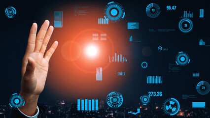 A hand gesture represents interaction with digital interfaces filled with graphs and data overlays, creating a futuristic ambiance against a city skyline background. Xenic