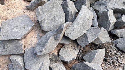 Gray Granite Stone Pile: Rough-Hewn Blocks and Gravel.