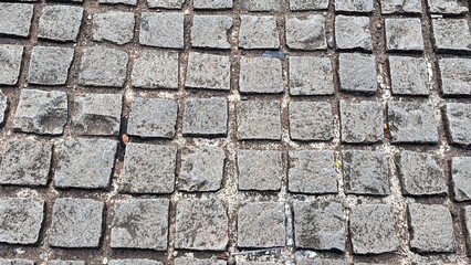 Rough Grey Cobblestone Pavement Surface Texture Background.