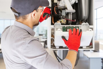 Technician in Red Gloves Repairing High-Tech Equipment in Modern Office Space with Bright Windows and Clean Aesthetic