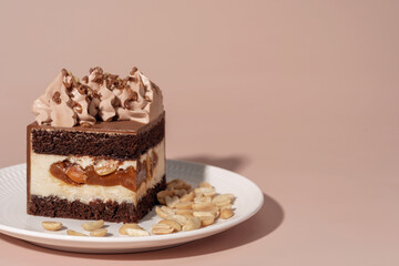 Caramel and nut bento cake with chocolate sponge layers, topped with creamy frosting, served on a white plate, perfect for dessert and pastry menu concepts with copy space
