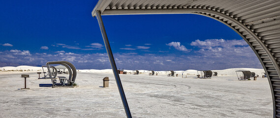 The portable picnic shelters look like sails scattered across the ocean.  Blocking the wind and sand, while providing some much need shade from the harsh sunlight. White Sands National Park
