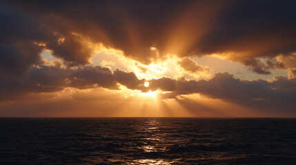 Sunbeams piercing through dramatic clouds over dark ocean waves sunset