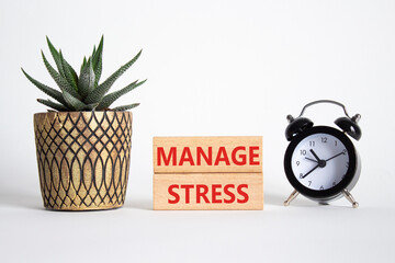 Manage stress symbol. Concept word Manage stress on wooden blocks. Beautiful white background with...