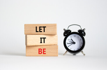 Let it be symbol. Concept words Let it be on wooden blocks. Beautiful white background with alarm...