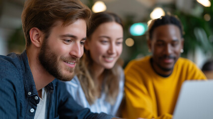 Fototapeta premium Young Diverse Entrepreneurs Collaborating Around Laptop in Cafe