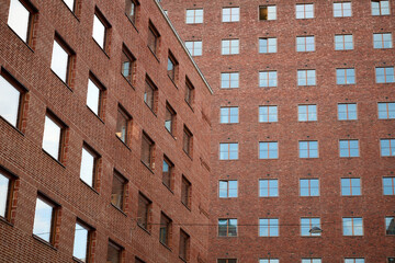 Red Brick Facade of Oslo City Hall with Repeating Window Patterns and Strong Geometric Lines in Urban Courtyard View