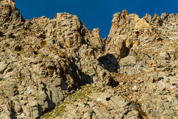 Ala-Archa Steep rugged rock formations dominate the landscape. Routes for climbers, trekkers, and mountaineers seeking adventure in remote alpine environments with dramatic vertical relief