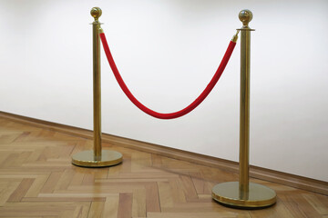 Golden barrier with red rope seamless line on a art gallery white wall background