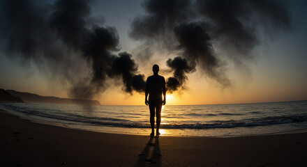 Silhouette of Man on Beach with Dramatic Smoke and Sunset Atmospheric Scene.
