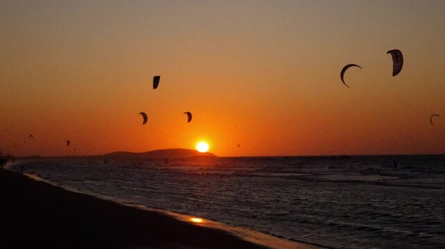 Golden sunset at Praia do Pre&aacute;, near Jericoacoara, with kitesurfers enjoying the waves.