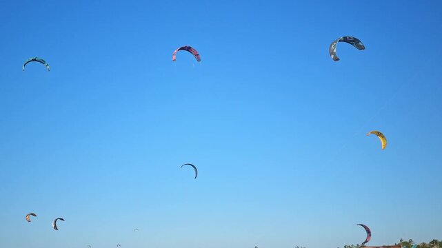 Colorful kitesurfing kites against a clear blue sky at Pre&aacute; Beach, Cear&aacute;, Brazil, highlighting the sport on a sunny day.