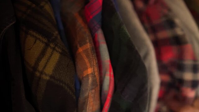 choosing a shirt in a closet full of plaid shirts