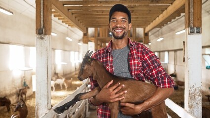 Portrait of handsome African American young male farmer in cap looking at camera and smiling...