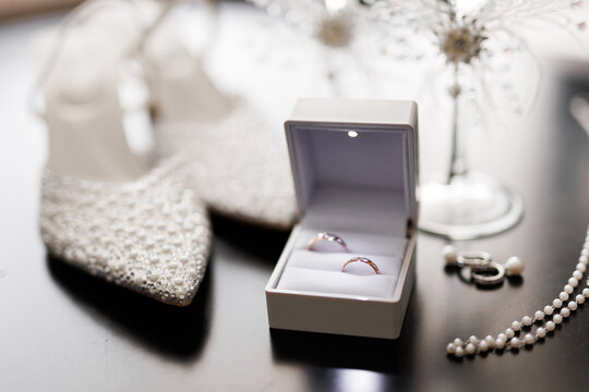 beautiful wedding rings of newlyweds in a box with bride's accessories - Powered by Adobe